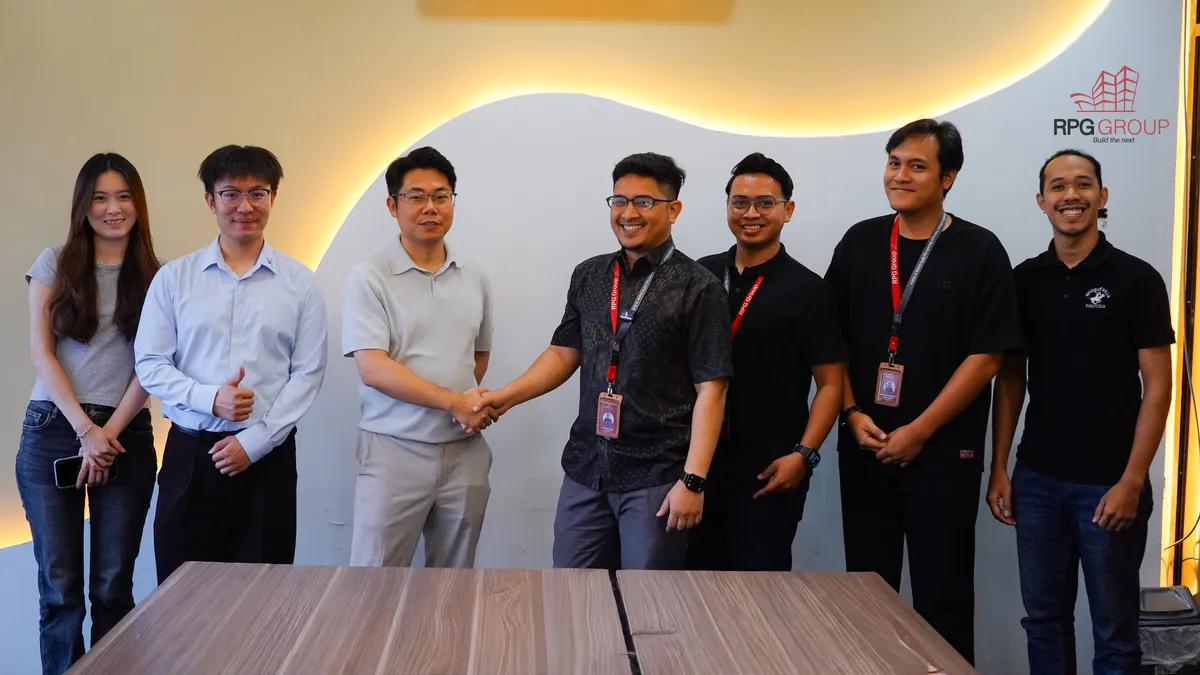 RPG Group team welcoming the Deputy General Manager of LV TOPSUN Guangdong and his team at RPG's office, with a handshake between representatives of both companies