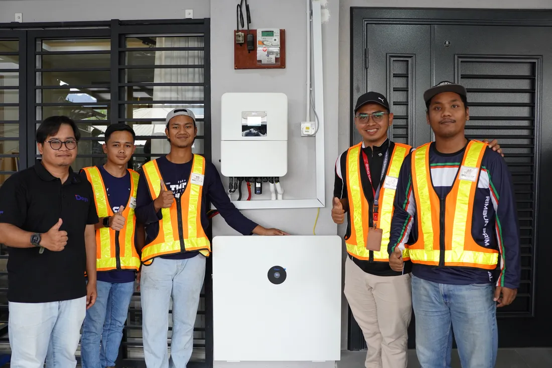RPG Green Technology installation crew with a homeowner in Gombak, Selangor, next to a completed hybrid solar and battery system