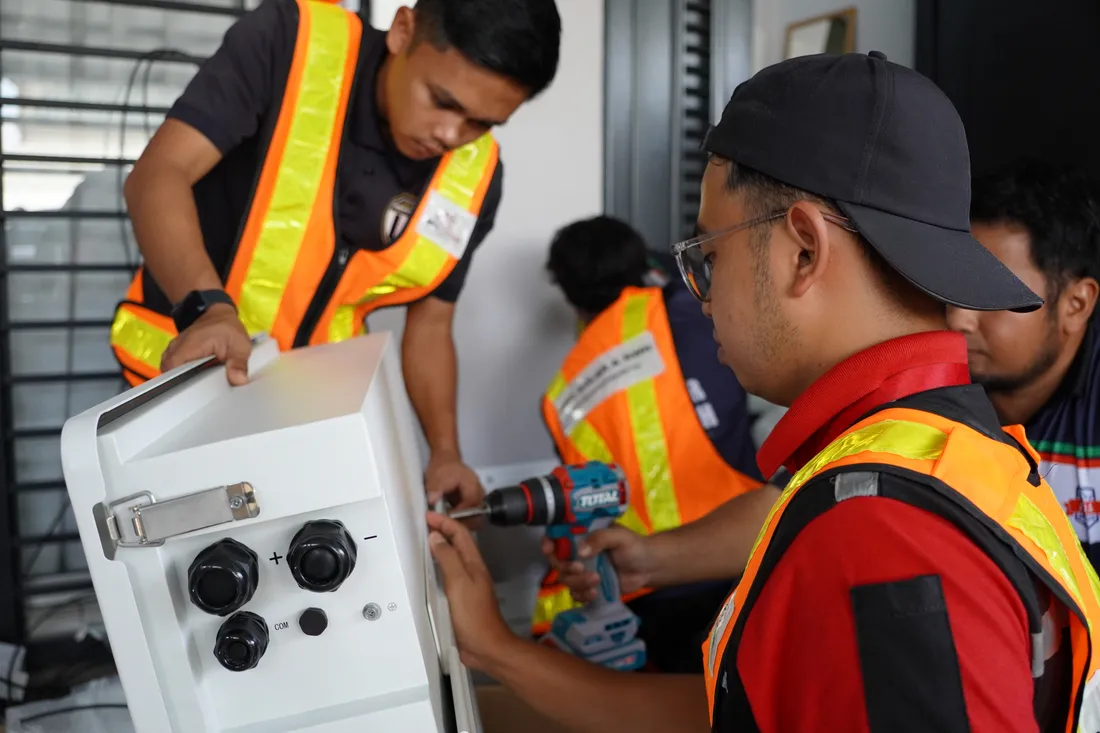 RPG Green Technology crew installing an inverter and battery unit at a residential home in Gombak