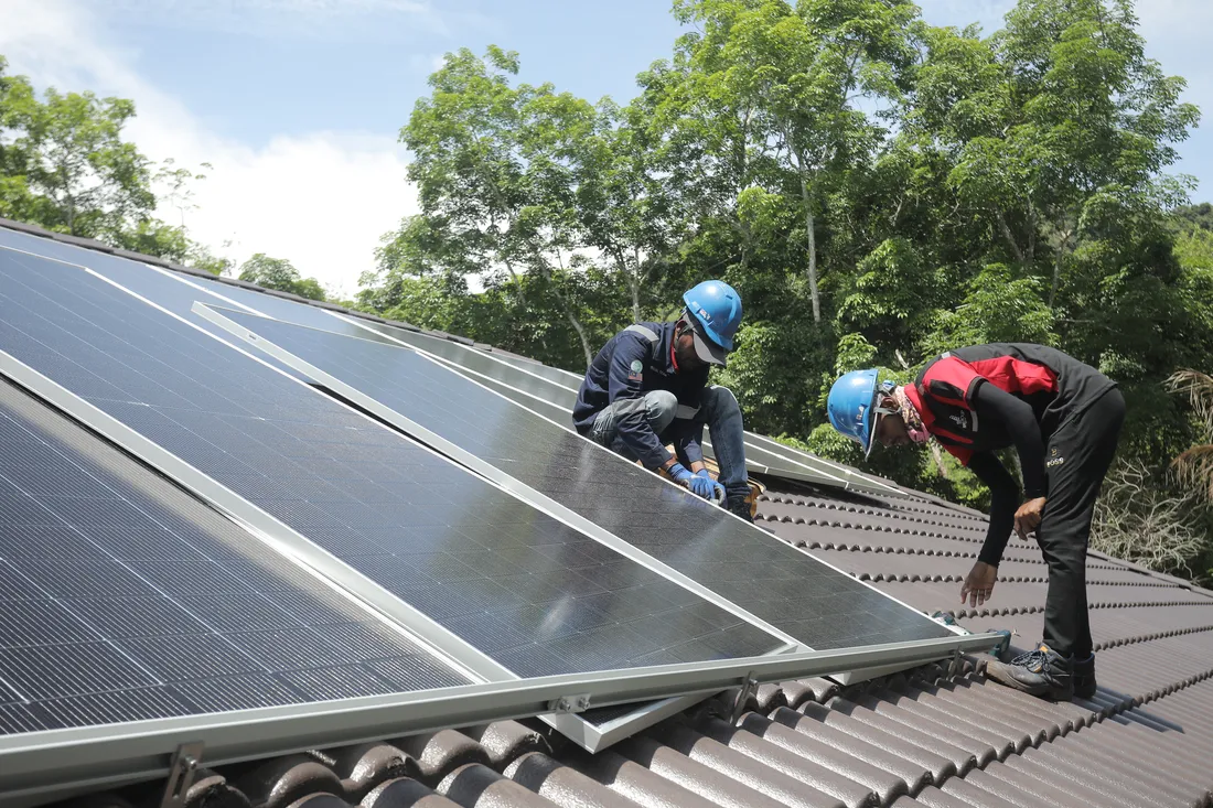 RPG Green Technology installation crew at work on a rooftop in Langkawi