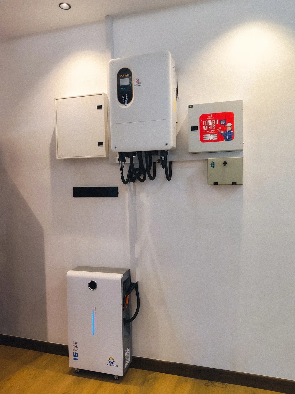 SolaX hybrid inverter and LVTOPSUN battery storage unit installed on a wall at an RPG customer's home